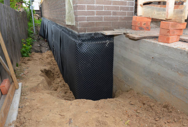 SJ Waterproofing Pros technician performing targeted Wet Basement Repair assessment in McConnell AFB, KS